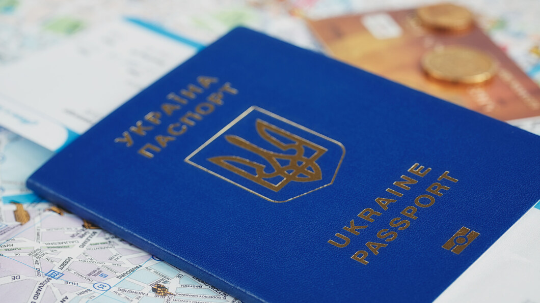 Oekraïens paspoort met tickets en kleingeld op een landkaart